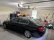 Garage interior with a parked car with some clutter in the background at 460 Heathrow Way, Stone Mountain, GA 30087