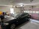 Garage interior with car and garage door with some storage and clutter at 460 Heathrow Way, Stone Mountain, GA 30087