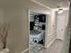 Inviting hallway leading to a cozy living room with fireplace and built-in shelving at 460 Heathrow Way, Stone Mountain, GA 30087