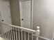 Upstairs hallway featuring carpet floors, white trim and doors at 460 Heathrow Way, Stone Mountain, GA 30087