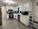 Kitchen with modern appliances, white cabinets and stainless steel appliances at 460 Heathrow Way, Stone Mountain, GA 30087