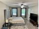 Spacious main bedroom with a ceiling fan and large windows for natural light at 460 Heathrow Way, Stone Mountain, GA 30087