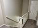 Carpeted staircase with white railing, leading to the upper level of this inviting home at 460 Heathrow Way, Stone Mountain, GA 30087
