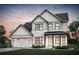Charming two-story home with white brick and siding, a covered porch, and manicured landscaping at 4790 Wayt Farm Overlook, Cumming, GA 30040
