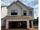 Charming two-story home with black framed windows and an attached two-car garage at 943 Crestmanor Dr, Marietta, GA 30008