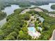 Aerial view of the community with a lake, pool, tennis courts, and lush greenery at 113 Stargaze Rdg, Canton, GA 30114