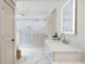 Bright bathroom featuring dual sinks, marble countertop, white cabinets, and a walk-in shower at 113 Stargaze Rdg, Canton, GA 30114