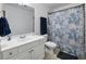 Clean bathroom with white vanity and a shower/tub combo with a stylish blue shower curtain at 113 Stargaze Rdg, Canton, GA 30114