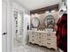 Rustic bathroom featuring dual vessel sinks, reclaimed wood wall, and patterned tile floor at 113 Stargaze Rdg, Canton, GA 30114