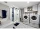 Bright bathroom featuring a glass-enclosed shower, modern vanity, and convenient washer and dryer at 113 Stargaze Rdg, Canton, GA 30114
