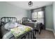 Charming bedroom featuring two wrought iron beds and light green walls, creating a relaxing atmosphere at 113 Stargaze Rdg, Canton, GA 30114