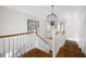 Bright hallway with hardwood floors, white railings, and modern lighting at 113 Stargaze Rdg, Canton, GA 30114