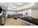 Open-concept living space with hardwood floors, a comfortable sofa, and an adjoining kitchen area at 113 Stargaze Rdg, Canton, GA 30114