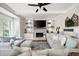 Comfortable living room with a fireplace, built-in cabinets, and lots of pillows on the sofas at 113 Stargaze Rdg, Canton, GA 30114
