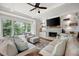 Cozy living room featuring a fireplace, built-in shelving, large windows, and comfortable seating at 113 Stargaze Rdg, Canton, GA 30114