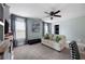 Comfortable living space with a sofa, a ceiling fan, and lots of natural light from the surrounding windows at 113 Stargaze Rdg, Canton, GA 30114