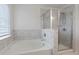 Well-lit bathroom featuring a separate shower and soaking tub with marble surround at 2231 Bedell Dr, Conyers, GA 30094