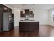 Well-equipped kitchen with dark cabinets, stainless steel appliances, and a center island at 2231 Bedell Dr, Conyers, GA 30094