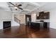 Open living space with a fireplace, coffered ceilings, and modern kitchen at 2231 Bedell Dr, Conyers, GA 30094