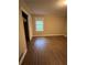 A bright bedroom with natural light and hardwood floors; closet access to the left at 276 Colewood Nw Way, Atlanta, GA 30328