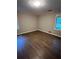 Bedroom with beautiful hardwood floors and natural light streaming through the window at 276 Colewood Nw Way, Atlanta, GA 30328