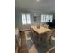 Bright dining room with natural wood table and shuttered windows at 276 Colewood Nw Way, Atlanta, GA 30328
