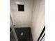 Modern shower featuring stylish black river rock floor and vertically stacked large white subway tile walls at 276 Colewood Nw Way, Atlanta, GA 30328