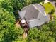 Aerial view of the home showcasing its private wooded lot and large back deck with outdoor seating area at 4789 Crest Park Ln, Marietta, GA 30068