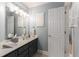 Powder room featuring a large mirror, decorative lighting, and white cabinets at 4789 Crest Park Ln, Marietta, GA 30068