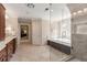 Bright bathroom featuring a glass shower, large soaking tub, and double vanity with wooden cabinets at 4789 Crest Park Ln, Marietta, GA 30068