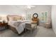 Cozy bedroom with a tray ceiling, ceiling fan, plantation shutters, and neutral decor at 4789 Crest Park Ln, Marietta, GA 30068