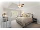 Bedroom with a tray ceiling, ceiling fan, plantation shutters, and neutral decor at 4789 Crest Park Ln, Marietta, GA 30068