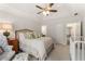 Bright bedroom with a tray ceiling, neutral decor, sitting area, and a luxurious upholstered bed at 4789 Crest Park Ln, Marietta, GA 30068