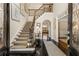 Elegant foyer with grand staircase, dark hardwood floors, and soaring ceilings welcomes you home at 4789 Crest Park Ln, Marietta, GA 30068