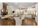 Open-concept kitchen with granite island, stone fireplace, and stainless steel appliances offers a welcoming space at 4789 Crest Park Ln, Marietta, GA 30068