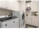 Modern laundry room with white cabinets, sink, and washer and dryer at 4789 Crest Park Ln, Marietta, GA 30068