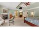 Spacious main bedroom with a fireplace, sitting area, ceiling fan, and lots of natural light at 4789 Crest Park Ln, Marietta, GA 30068