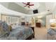 Spacious main bedroom with a fireplace, tray ceiling, ceiling fan and sitting area at 4789 Crest Park Ln, Marietta, GA 30068