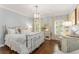 Serene main bedroom with soft blue walls, wood floors, and plantation shutters at 4789 Crest Park Ln, Marietta, GA 30068