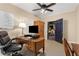 Home office with a desk, ergonomic chair, TV and a view to the living area at 4789 Crest Park Ln, Marietta, GA 30068
