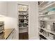 Walk-in pantry with shelving and easy access to kitchen appliances at 4789 Crest Park Ln, Marietta, GA 30068