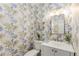 Charming powder room with designer wallpaper, white vanity, and elegant fixtures at 4789 Crest Park Ln, Marietta, GA 30068