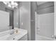 Bathroom featuring single vanity, mirror, and shower-tub combo at 903 Duncan Ter, Canton, GA 30115