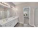 Bathroom highlighting dual sinks, vanity with storage, and doorway to adjacent bedroom at 903 Duncan Ter, Canton, GA 30115