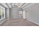 Expansive bedroom featuring a tray ceiling, ceiling fan, and ensuite bathroom for added privacy at 903 Duncan Ter, Canton, GA 30115