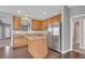 Bright kitchen with wooden cabinets, stainless steel appliances, and an island with barstool seating at 903 Duncan Ter, Canton, GA 30115