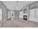 Open-concept living room featuring a fireplace, built-in shelving, and abundant natural light at 903 Duncan Ter, Canton, GA 30115