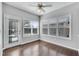 Bright sunroom with hardwood floors, ceiling fan, and multiple windows providing natural light at 903 Duncan Ter, Canton, GA 30115