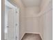 A walk-in closet with shelving and a view into an adjacent bathroom at 903 Duncan Ter, Canton, GA 30115