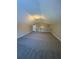 Carpeted attic space with vaulted ceilings and neutral paint at 12 Barrington Ct, Sharpsburg, GA 30277
